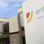 Tan and beige building with sign that reads "Enthermics Medical Systems"